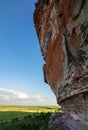 Arenite rock, in Jalapao, Brazil, contrasting with the blue sky and green fields.