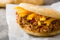 Arepa with shredded beef and cheese on wood. Venezuelan typical food Royalty Free Stock Photo