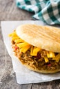 Arepa with shredded beef and cheese on wood. Venezuelan typical food Royalty Free Stock Photo