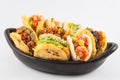 Arepas with assorted fillings served in a black ceramic dish Royalty Free Stock Photo
