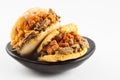 Arepas filled with shredded beef and pork rind served in a black ceramic dish Royalty Free Stock Photo