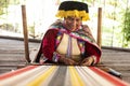 Arequipa, Peru; May 13th, 2019: Quechua lady weave traditional texile using Alpaca wool