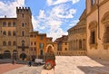 AREZZO, ITALY. Cityscape with Piazza Grande square in Arezzo with facade of old historical buildings and young woman re