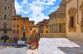 AREZZO, ITALY. Cityscape with Piazza Grande square in Arezzo with facade of old historical buildings and young woman re