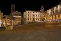 Arezzo, Tuscany, Italy: night view of the main square Piazza Grande, with the medieval church and buildings, in the old town of Royalty Free Stock Photo