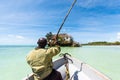 Arfican on the boat sailing to tha Rock restaurant in ocean Royalty Free Stock Photo