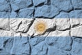 Argentina flag depicted in paint colors on old stone wall closeup. Textured banner on rock wall background Royalty Free Stock Photo