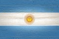 Argentina flag painted on old wood plank background. Brushed natural light knotted wooden board texture. Wooden texture background Royalty Free Stock Photo