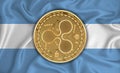 Argentina flag, ripple gold coin on flag background. The concept of blockchain, bitcoin, currency decentralization in the country