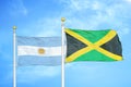 Argentina and Jamaica two flags on flagpoles and blue sky
