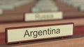 Argentina name sign among different countries plaques at international organization. 3D rendering