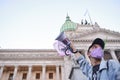 Argentine activist raising a megaphone with a text in favor of veganism