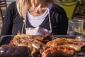 Argentine barbecue and a woman in the background out of focus