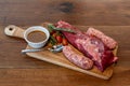 Argentine cut of meat called Vacio with chorizos and chimichurri Royalty Free Stock Photo