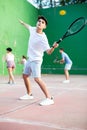 Argentinian guy playing frontenis at open-air fronton court in summer