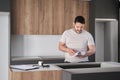 Argentinian man read instruction manual before installing kitchen furniture. Royalty Free Stock Photo