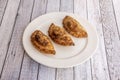 Argentinian puff pastry empanadas stuffed with traditional beef stew well toasted on a plain white plate