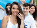 Argentinian woman with other soccer fans and flag Royalty Free Stock Photo