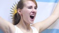 Argentinian Young Woman celebrates holding the Flag of Argentina in Slow Motion Royalty Free Stock Photo