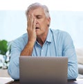 Argh, come on. a mature man sitting alone and feeling stressed while using his laptop to work from home.