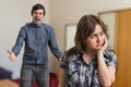 Argue of young couple. Angry man is arguing and sad woman is ignoring him