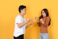 Arguing Asian couple isolated on yellow background Royalty Free Stock Photo