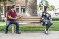 Arguing Mixed Race Couple Sitting Facing Away From Each Other on Park Bench Royalty Free Stock Photo