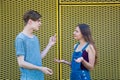 Arguing teenagers gesticulating with question
