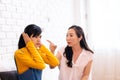 Argument between annoyed Asian teenage daughter and upset middle aged mother. Royalty Free Stock Photo