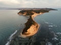 Arial shot of the a rocky cape of Rodon surrounded by the sea, Albania
