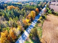 Arial veiw of rural road, fields and autumn trees.