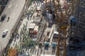 Arial view of a big group of construction workers, grouped on side of the road