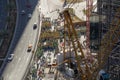 Arial view of a big group of construction workers, grouped on side of the road