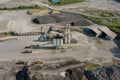 Arial view of the open pit mine gravel into stone crusher in heavy mining machinery equipment for earthworks Royalty Free Stock Photo