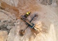 Arial view of the sand open-pit mining with heavy mining machinery. Mobile stone jaw crusher machine in open pit mine. Wheel