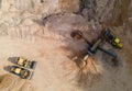 Arial view of the sand open-pit mining with heavy mining machinery. Mobile stone jaw crusher machine in open pit mine. Wheel