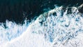 Arial view of splashing oceanic waves with bubbles and foam