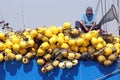 Fisherman repairing nets in Arica, Chile