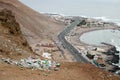 ARICA, CHILE, 2017-01-26: view to the trash in the desert in mountains and highway and beach at the background