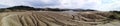 Panoramic view of an arid landscape at the Mud Volcanoes Royalty Free Stock Photo