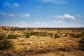 Arid landscape with town in background, Jaisalme