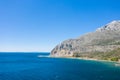 The arid rocky coast and its green countryside, in Europe, in Greece, in Aetolia Acarnania, towards Patras, by the Ionian Sea, in Royalty Free Stock Photo