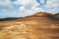 Arid volcanic landscape with lava fields in Timanfaya National Park, Lanzarote, Canary Island, Spain Royalty Free Stock Photo