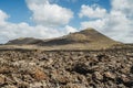 Arid volcanic landscape with lava fields in Timanfaya National Park, Lanzarote, Canary Island, Spain Royalty Free Stock Photo