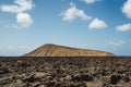 Arid volcanic landscape with lava fields in Timanfaya National Park, Lanzarote, Canary Island, Spain Royalty Free Stock Photo