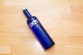 Skyy Vodka blue bottle on a wooden table laying down Royalty Free Stock Photo