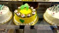 arious Cake with Icing in Refrigerated Bakery Case Cabinet - Image