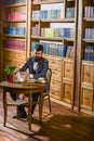 Aristocrat on thoughtful face reading book. Oldfashioned man holds cup