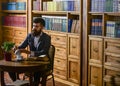 Aristocratic lifestyle concept. Man in classic suit sits Royalty Free Stock Photo