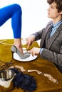 Aristocratic man, young guy in office suit eating female leg in blue leggings like delicious dish in restaurant. Royalty Free Stock Photo